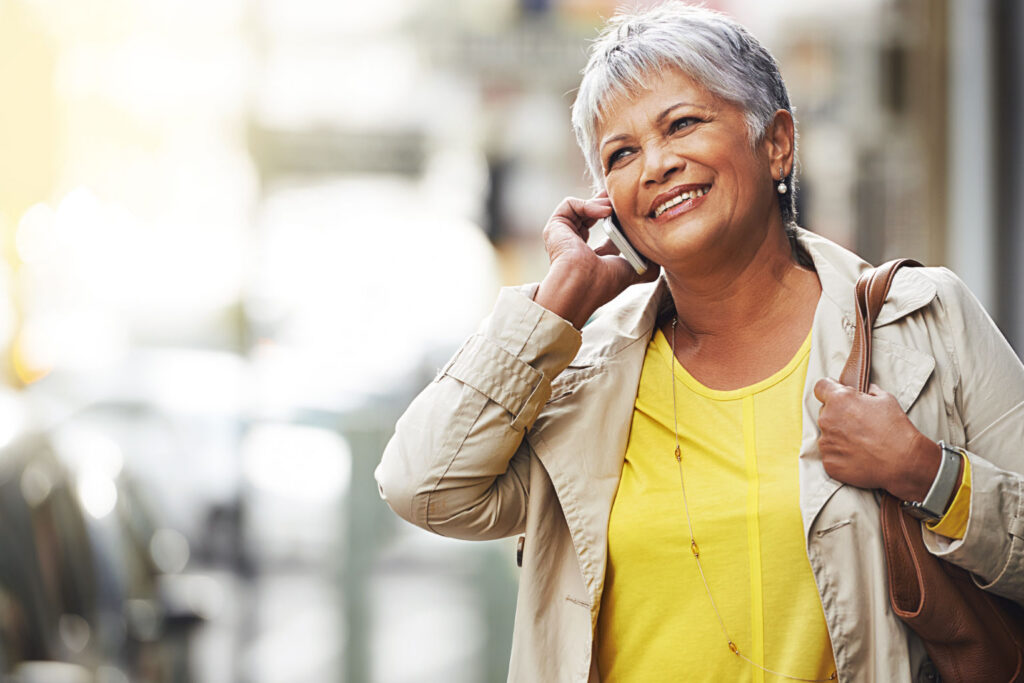 Older woman talking on a smartphone outdoors
